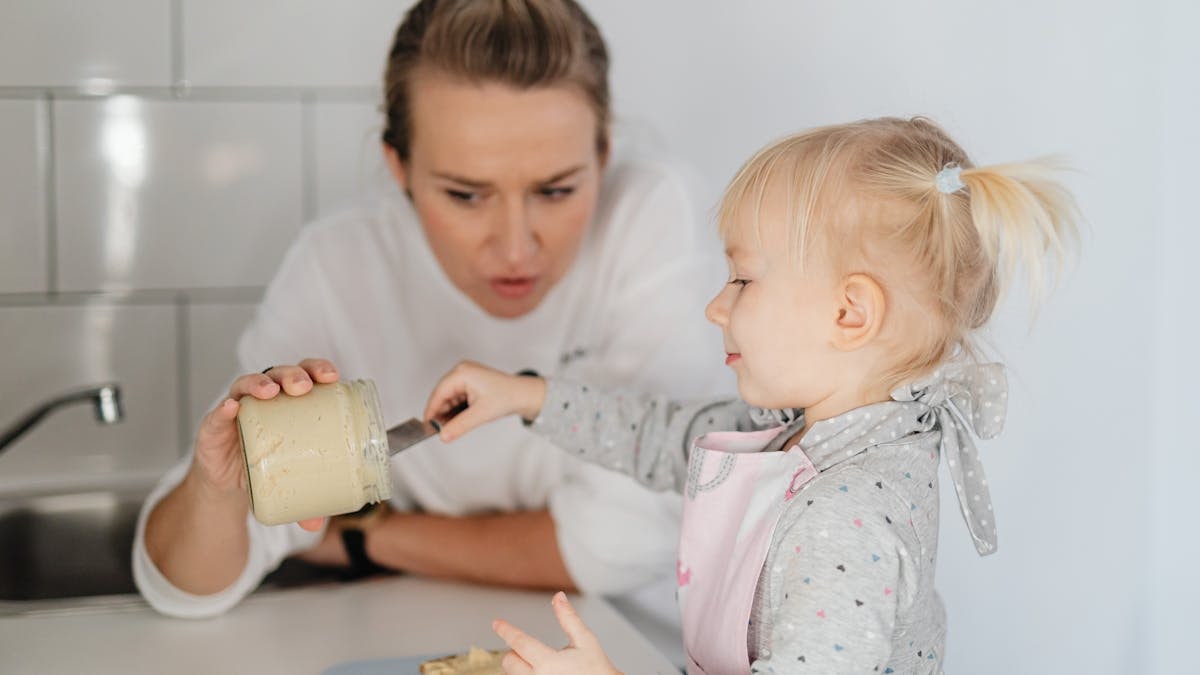A mother and daughter bonding over baking, enjoying time in the kitchen.
